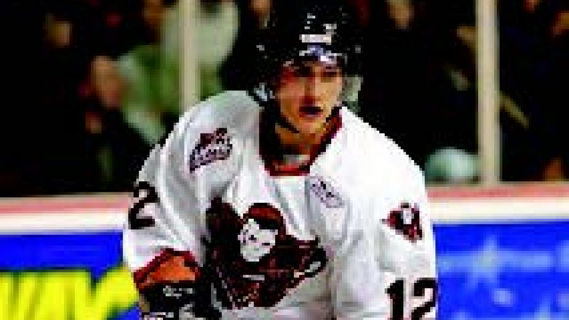 Brett Sonne glides across the ice of a hockey rink.